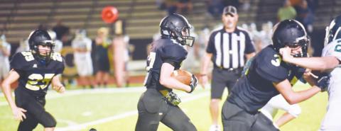 Grant McWherter, center, picks up a first down and more as #3, Jaecob Titman and #25 Trent Korman run interference. Photo by Randall Luker