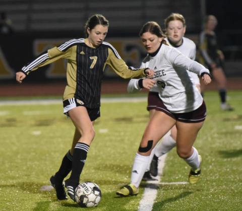Lady Pirate Chloe Post slips past a Silsbee defender in Tuesday’s district opener in Vidor.. Photo by Randall Luker