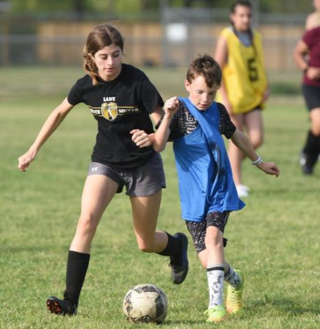 Vidor Junior High plans to field both boys and girls 7th and 8th grade soccer teams in the fall of 2022 competing against a number of other district schools. These youths are practicing at the junior high as part of an intramural league playing many of those same future district opponents. This is the second year for the local teams to play. Volunteer coaches lead the practices as they teach fundamentals of the game in prepartion for the VISD to join UIL play next school year. Photo by Randall Luker