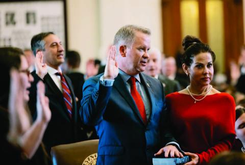 State Rep. David Cook, R-Mansfield, takes the oath of office with his hand on a bible on the first day of the 88th legislature on Jan 10, 2023. Credit: Jordan Vonderhaar for The Texas Tribune