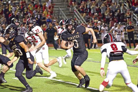 Pirate running back Isaac Fontnow runs left for a first down Friday against the Huffman Falcons.