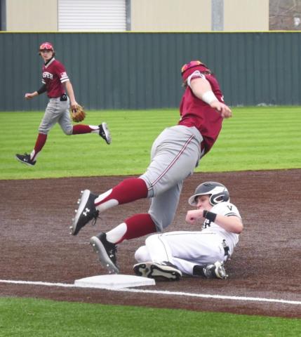 Easton Walker slides to safety as he steals third base versus Jasper Saturday in the Bridge City tournament.