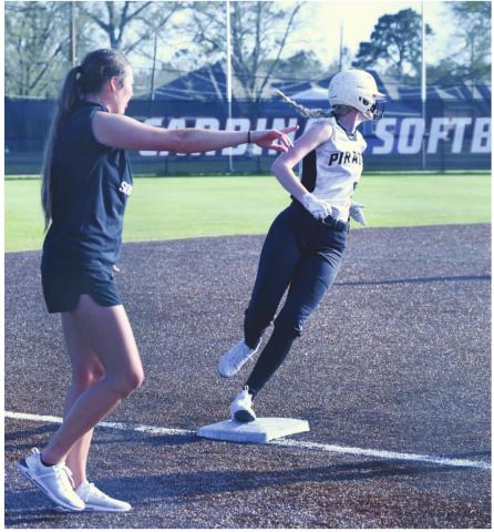Lady Pirate Mallory Guillot keeps her eye on the play as she rounds third base under the direction of Coach Brooklyn Sampere.