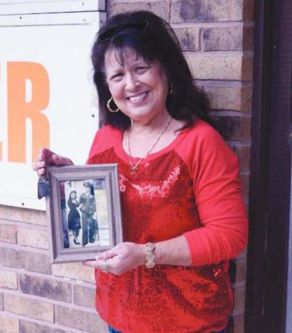 Miriam Vogel Hodges holds her dad’s long lost dogtags along with a wedding photo of her parents, J.P. and Frances L. Vogel.