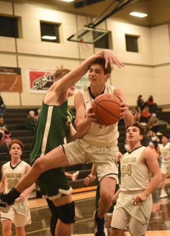 Branson Healy is fouled as he moves in for a shot in Tuesday’s home game versus the LCM Bears. The junior varsity Pirates lost 38-33 in a late change of lead. Photo by Randall Luker