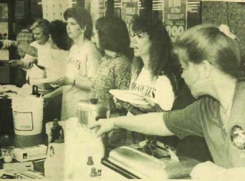 Supporters of the Vidor High School Brigadettes drill team were dishing out pancakes to a hungry public early in front of Woods Supermarket. Late in the morning, they changed to hot dogs, all to raise money for the drill team to go to the Cotton Bowl classic next New Year's Day. Archive Photo