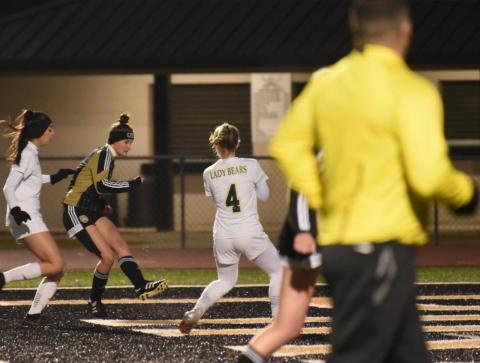 Lady Pirate Jaden Lee sends the ball between LCM defenders for a goal in the varsity match Friday. Photo by Randall Luker