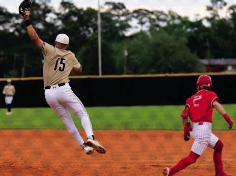 Pirate first baseman Jarrett Odom jumps to pull in an overthrown ball in Monday’s loss to Bridge City. Photo by Randall Luker