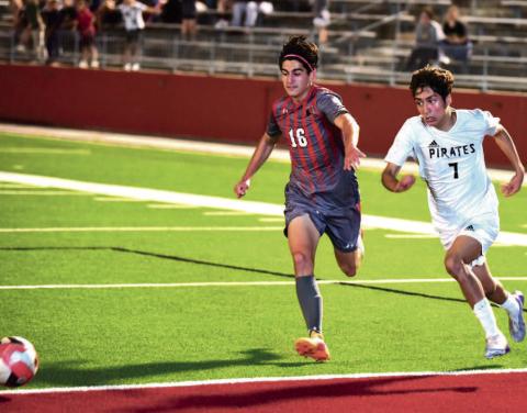 Sami Estupinan races a Huffman player for control of the ball in Friday’s bi-district playoff game in Beaumont. Photo by Randall Luker
