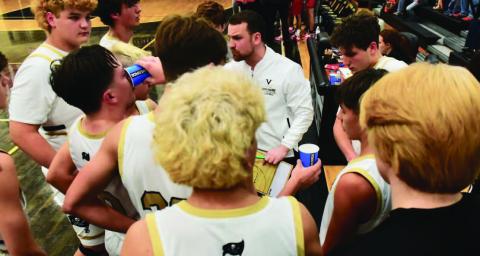 Varsity boys basketball coach Joseph Hoyt talks strategy during a timeout. File Photos