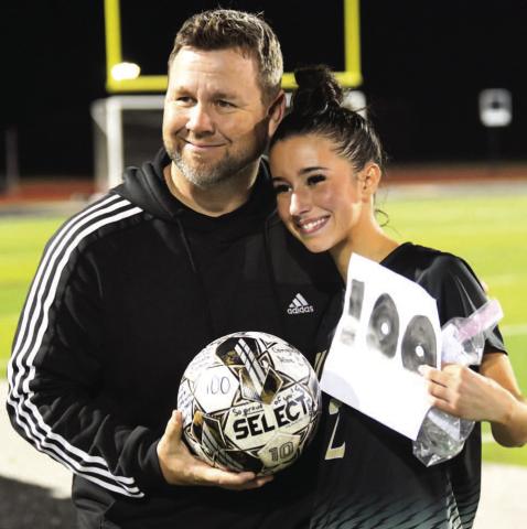 Vidor Head Girls Soccer Coach Ralph Fields poses with VHS senior Taylor Bull after she scored her 100th career goal last night versus Silsbee in this season’s first district game. “Taylor has been a dominant scoring threat for the Lady Pirates as she currently leads the team in scoring so far this season with 16 goals and she broke the school’s single season scoring record last year scoring 45 total goals,” Fields said.