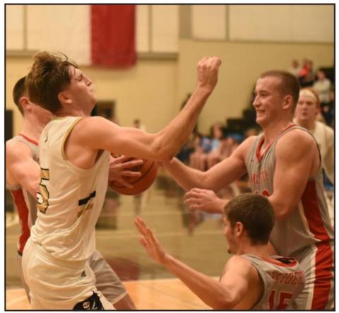Joe Gardenhire is met with a wall of Raiders as he attempts to shoot in Tuesday’s home game. Photo by Randall Luker