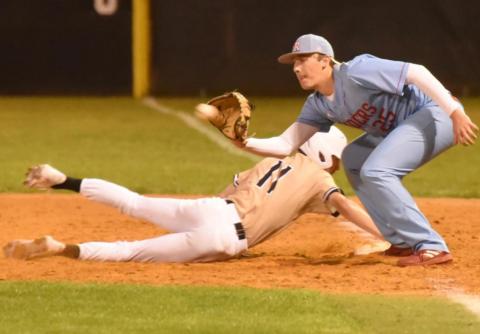Ty Watson dives back to first base as the Lumberton pitcher tries to pick him off. Photo by Randall Luker