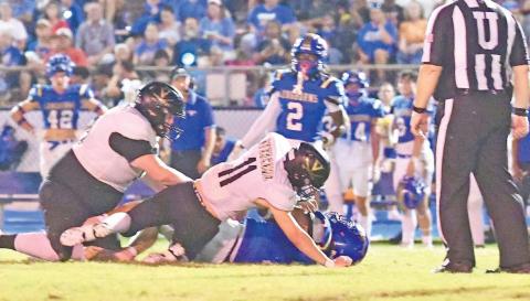 Brody Bloss, #11, and Owen Stephenson, #79, stop a H-F ball carrier Friday at Hamshire.