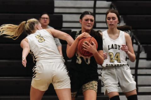 Lady Pirates Raegan Stephenson , left and Hailey Stelly, right, put the squeeze on a Lady Bear Tuesday in Pirate Gym. Photo by Randall Luker