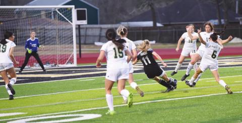 Vidor’s Brooklyn Healy sends her 100th career goal toward the net in Friday’s match with LCM.