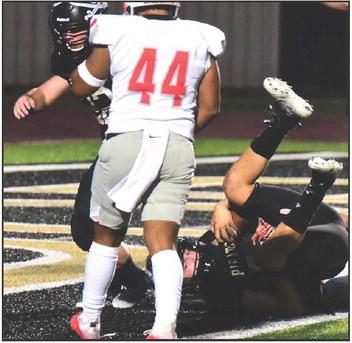 Jarrett Odom is upended as he scores a touchdown. Also pictured is blocking back Caleb Dean. Photos by Randall Luker