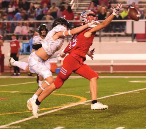 Dayton Whimire gets his hand in to break up a Raider pass Friday.