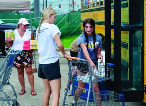 Vidor ISD student volunteers help Fill the Bus during the annual school supply drive last year. This year’s drive takes place Saturday at the Brookshire Brothers parking lot from 9 a.m. until noon. Photo by Randall Luker
