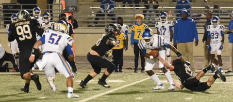 Lane Copelan, #20, right, manages to get a grasp on Chapel Hill QB Demetrious Brisbon as #68, Tyler Rojas, approaches to help. Jordan Smith, #99, moves to seal the outside. Photo by Randall Luker