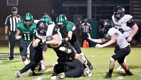 Brody Bloss fights through several Lion defenders to score.