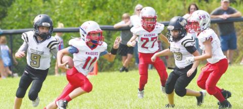 Junior White defenders #9 Karaon Cudd and #18 Carlos Gutierrez pressure the Lumberton QB in Saturday action.