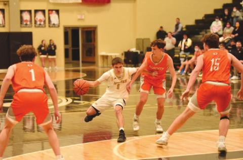 Nathan Bullard fends off Bobcat defender as he drives toward the goal.