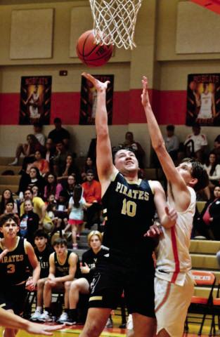 Camden Young shoots past a block in Saturday’s championship game versus tournament host Orangefield. Photo by Randall Luker
