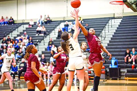 Allie Williams shoots A Silsbee defender swats at the ball as Vidor’s Allie Williams shoots from the paint Friday in Pirate Gym.