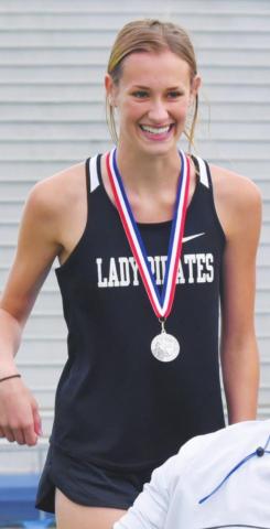 Jaden Lee smiles after receiving her medal for 2nd place in 100M hurdles.