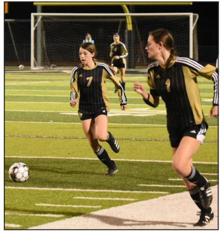 Lady Pirates Chloe Post, #7, and Jaden Lee, #1, team up to move the ball into scoring position versus Cleveland. Photo by Randall Luker