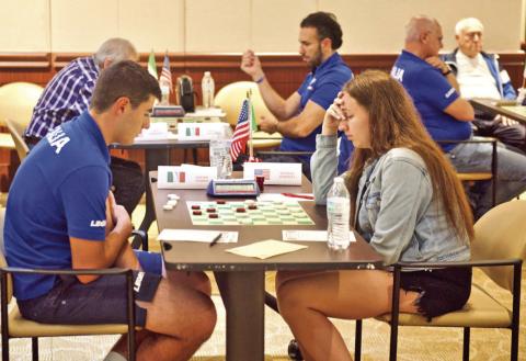 Team USA’s Tetiana Zaitseva and Team Italy’s Davide Gemma concentrate on the playing board during their match Tuesday at Vidor City Hall.