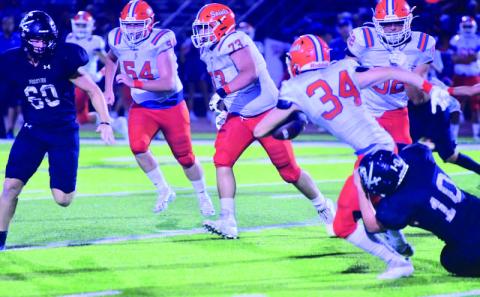 Keaton Abshire pulls down a Saints runner as Hayden Garrett moves in to assist. Photo by Randall Luker