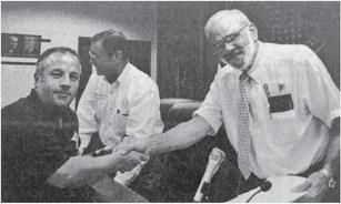 Orange County Judge Carl Thibodeaux, right, and the Orange County Sheriff’s Office Employee Association negotiator Lt. Tom Ray, left, had smiles on their faces as they shook hands after the Commissioners Court tentatively agreed to the union’s contract offer on Monday.