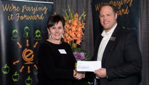Sally Andrews, Director of Community Relations, VISD, receiving checks for Vidor Junior High and Oak Forest Elementary