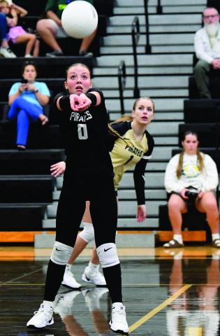 Loghan Matherne sets the ball for Makena Travis in Friday’s home game versus LCM.