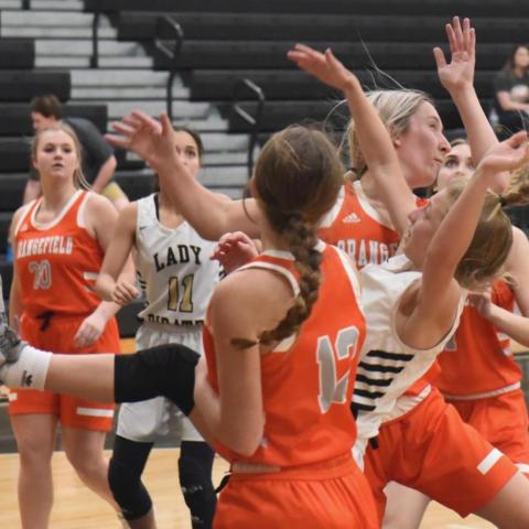 Lady Pirate Mia Robin is upended as she shoots in Tuesdays district game versus Orangefield. Photos by Randall Luker