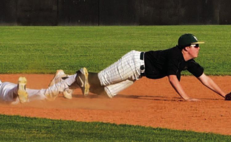 Alex Parish, diving headfirst into second base, is safe after a throwing error. The junior varsity defeated the LCM Bears in Vidor. Photos by Randall Luker