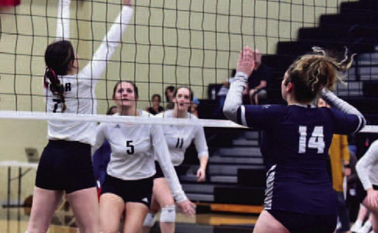Brilie Cornelison #7 sets the ball for Madison Powell #5 in the Lady Pirates home district opener versus WOS.  Photo by Randall Luker