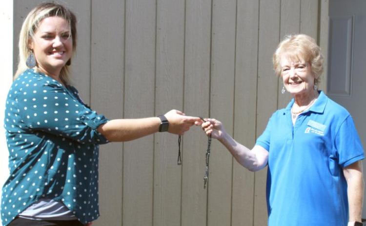 Laura Roberts, Team Leader of Leadership Southeast Texas Orange County Team #1 presents the key to a new storage building to Clara Fults, Assistant Director at Birthright of Orange.