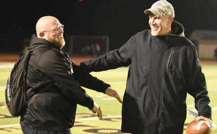 Photo by Randall Luker Vidor Pirate football offensive coordinator Mike Trahan, left, and Vidor Head Football Coach and Athletic Director Jeff Mathews are all smiles after the Vidor Pirates clinched the top spot in district Friday by defeating the Lumberton Raiders 28-27, overcoming a 20 point deficit.