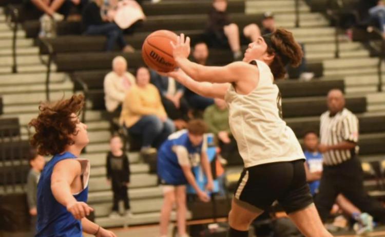 Photo by Randall Luker Blayne Holcom takes a shot versus Kelly Saturday.