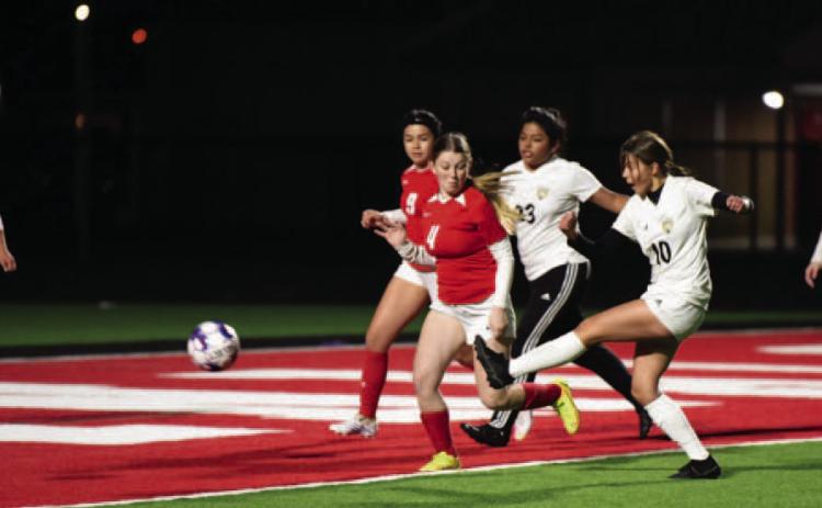 Gracelen Simmons, #10, sends the ball in for a score in the junior varsity match against Bridge City Friday. Photo by Randall Luker