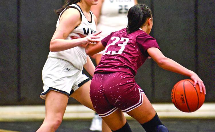 Guarding a Tiger A Silsbee Lady Tiger tries to get past Vidor’s Kinsey Dillard in Fridays’ game at Pirate Gym.