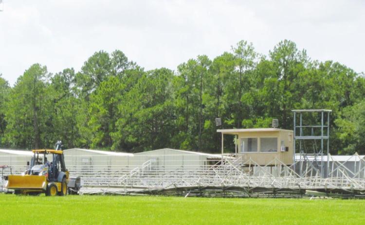 The high winds of Hurricane Laura picked up one entire section of bleacher seats at the Vidor Junior High football field, flipped it over and tossed them onto the playing turf. At the temporary Oak Forest Elementary School campus Laura’s fury ripped off a whole section of center walkway awning that workmen have already replaced. Photo by George Garza