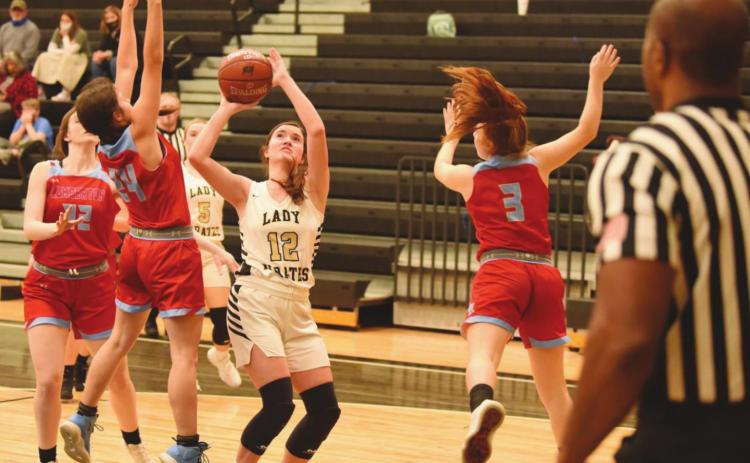 Ava Lightfoot keeps her eye on the goal as she shoots between two Lady Raiders.