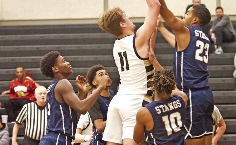 Root Shoots In a Crowd Brayden Root shoots over a Mustang defender Tuesday in Pirate Gym.