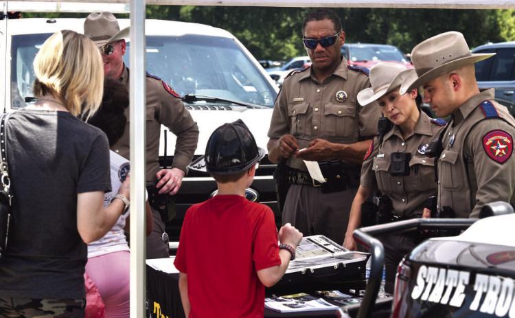 Sergeant Richard Standifer and Troopers Alt, Arauz and Salinas manned the Texas Department of Public Safety booth at the Cops N Kids event answering questions, handing out pamphlets and interacting with parents and kids.