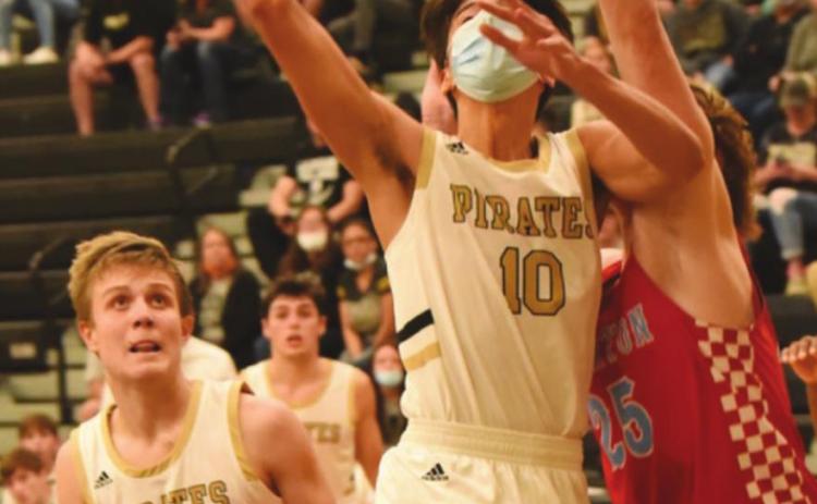 Aiden Ochoa, #10, takes a shot as #23, Easton Walker watches for a rebound. Dayton Whitmire is in the background. The Pirates lost 57-44.