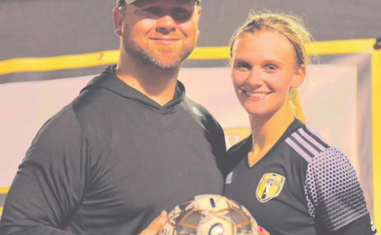 Brooklyn Healy with Coach Ralph Fields after scoring her 100th career goal.